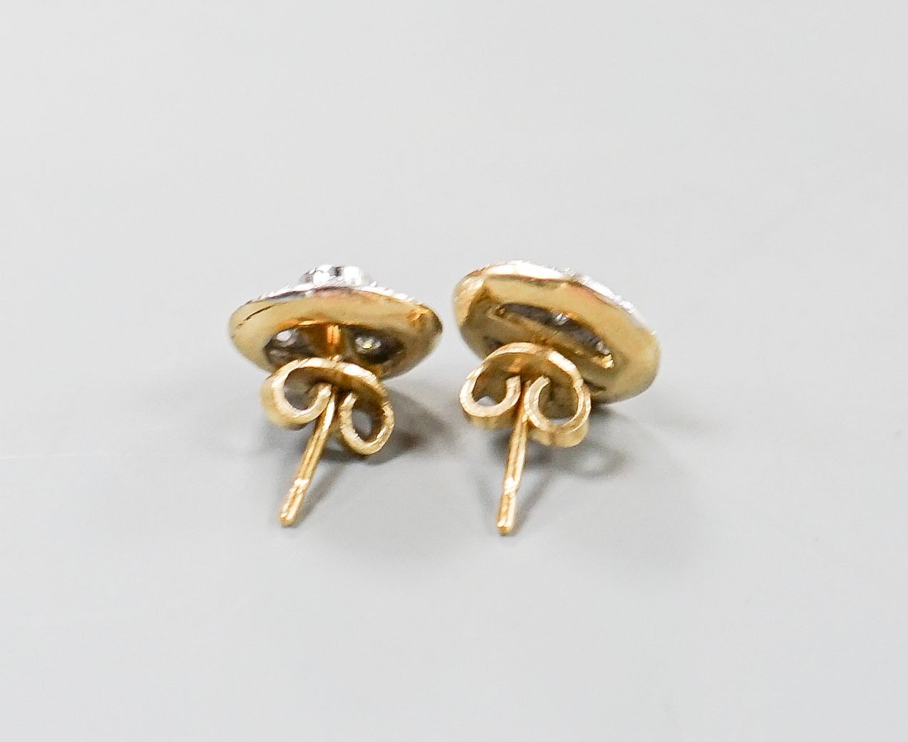 A pair of 18k yellow and white metal, diamond chip set circular ear studs, 12mm, gross weight 5.6 grams.